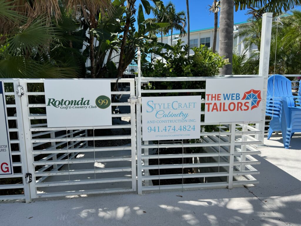 sponsor logos hanging of a fence